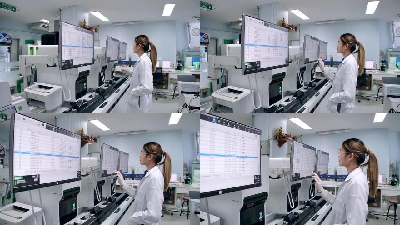 科学家使用计算机进行数据验证并使用触摸屏在操作中使用现代技术。4k分辨率慢动作。