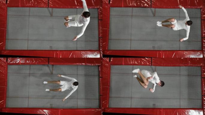 穿着白色衣服的俯视图体操运动员杂技演员在蹦床上进行慢动作翻筋斗