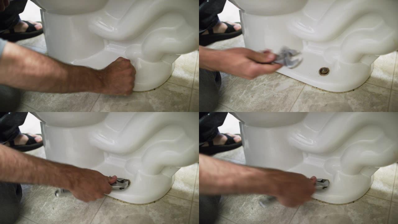 一名高加索修理工卸下螺栓盖，并使用可调扳手松开螺母，将马桶用螺栓固定在室内家庭浴室的地板上