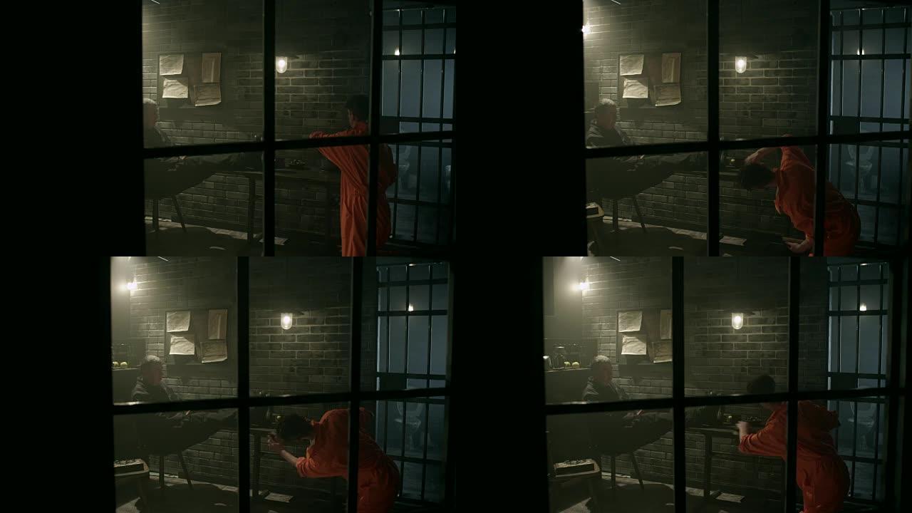 男囚犯在监狱通过窗户清理桌子