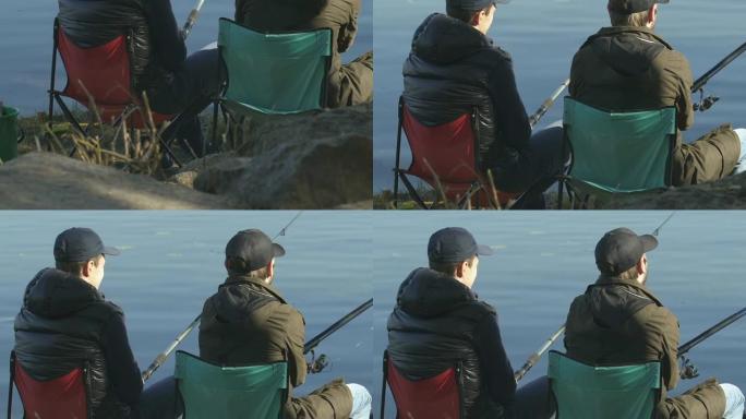 男性朋友钓鱼，坐在折叠椅上，户外休闲活动