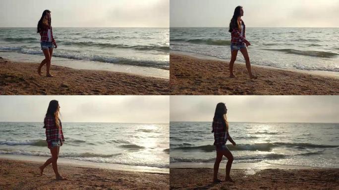 年轻浪漫的女人漫步在海滩上享受日落，跟踪拍摄