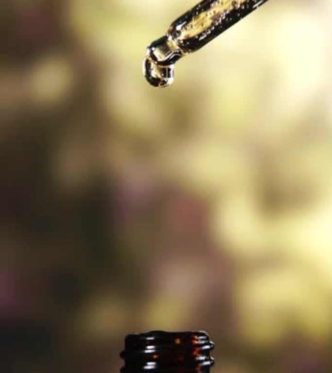 垂直射击: 慢动作液滴从移液管掉落到具有中心成分的瓶子中