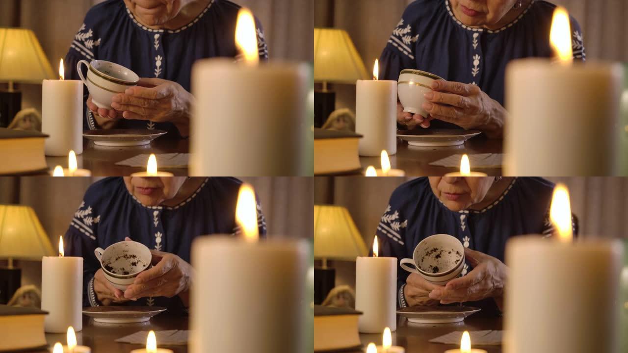 老高加索女巫拿着咖啡杯和阅读命运的肖像。高级女性用咖啡渣讲述命运。占卜、描画、预测。电影院4k Pr