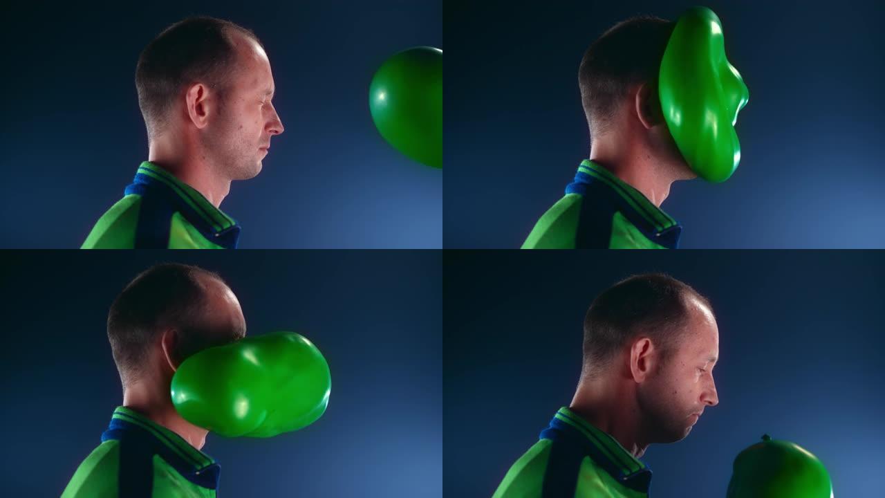 SLO MO LD充满绿色水的气球击中了一个男人的脸而没有弹出
