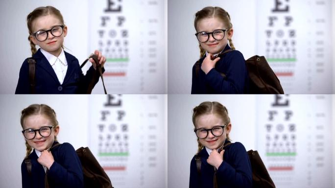 戴眼镜的漂亮女学生微笑，意识到上学前的全面眼科检查