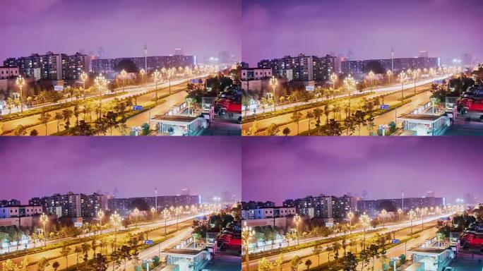 中国昆明夜间的柏油路路和现代天际线城市景观