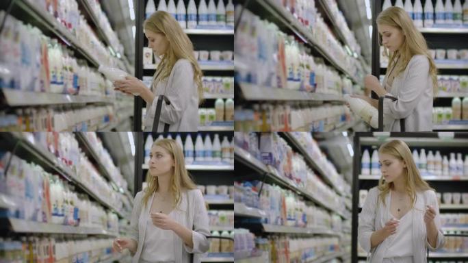 广告，商业，食品，健康概念-女人在超市里站在冰柜前，选择购买新鲜奶瓶。喝牛奶健康