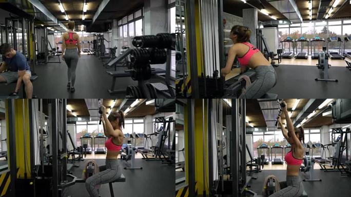 女运动员进入健身房并在侧向下拉举重锻炼机上锻炼。