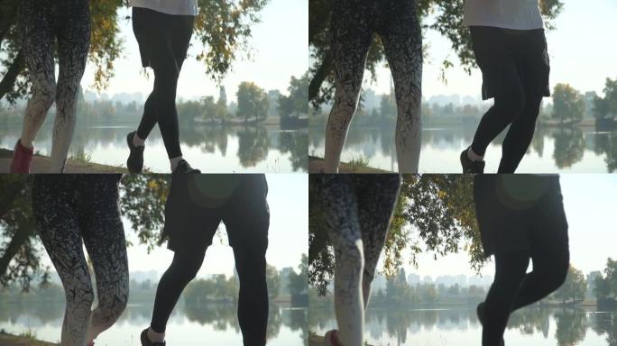 男性和女性的腿在河边奔跑