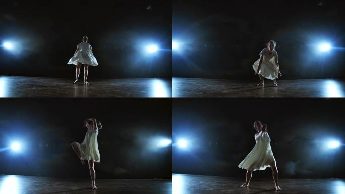 一个穿着白色连衣裙的女孩在舞台上跳舞，在聚光灯下抽烟，在舞台上旋转。