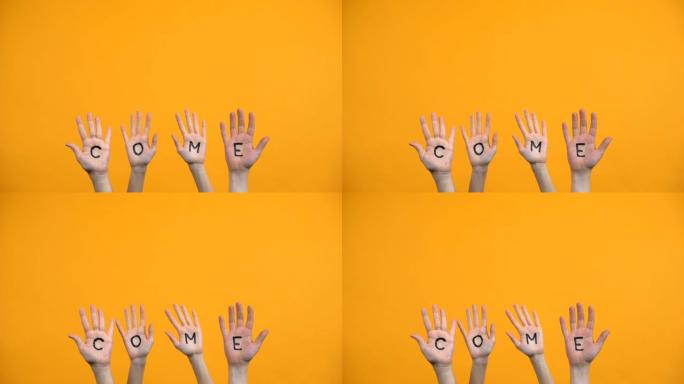 来写手掌在橙色的背景，积极分子的手，项目报告