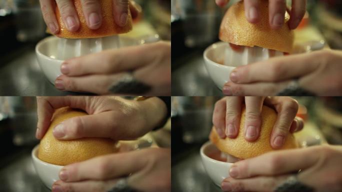一名白人妇女使用手动榨汁机从葡萄柚中榨汁的特写镜头
