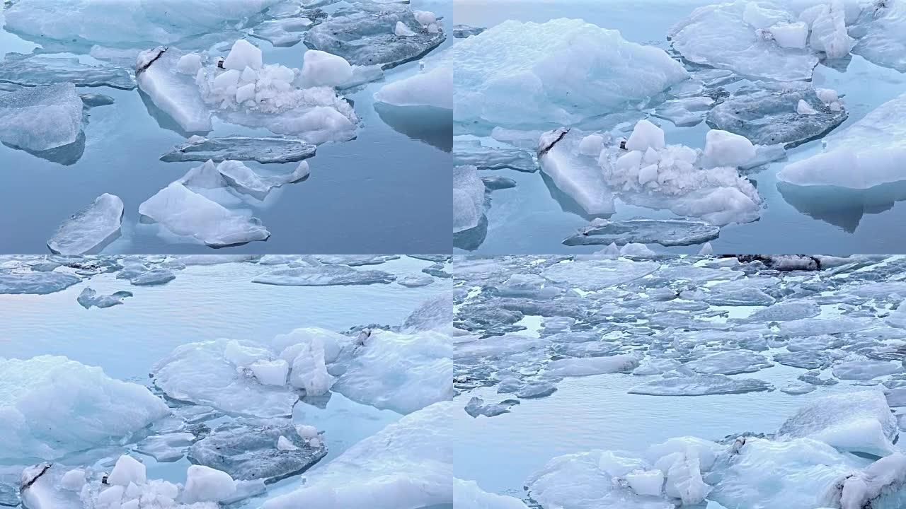 电影倾斜: 冰山漂浮在Vatnajokull冰川冰岛的Jokulsarlon泻湖中