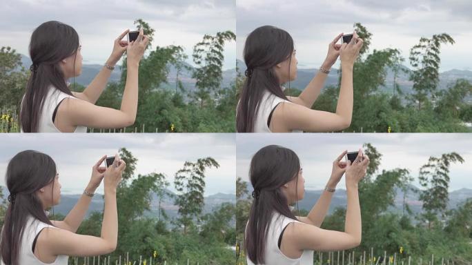 亚洲美女使用智能手机山景