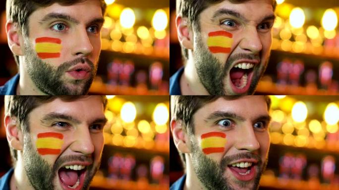 西班牙足球迷在脸颊上举着旗子，欢欣鼓舞最喜欢的球队胜利，联赛