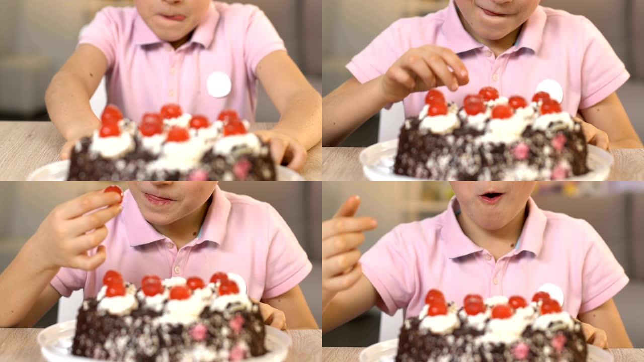 快乐的男孩从奶油蛋糕上吃樱桃，不健康的饮食，肠胃病学