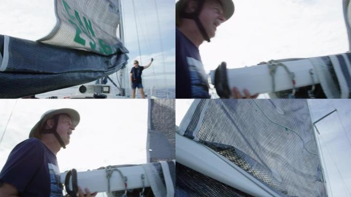 一名60多岁的男子看着他的船员在华盛顿州西雅图附近的普吉特海湾吊起帆船的主帆