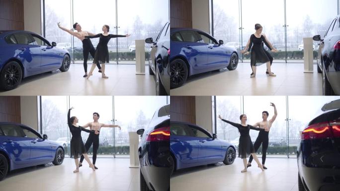 年轻的高加索芭蕾舞演员在汽车经销店跳舞的长镜头。男人和女人在汽车陈列室表演经典舞蹈。艺术，优雅，生活