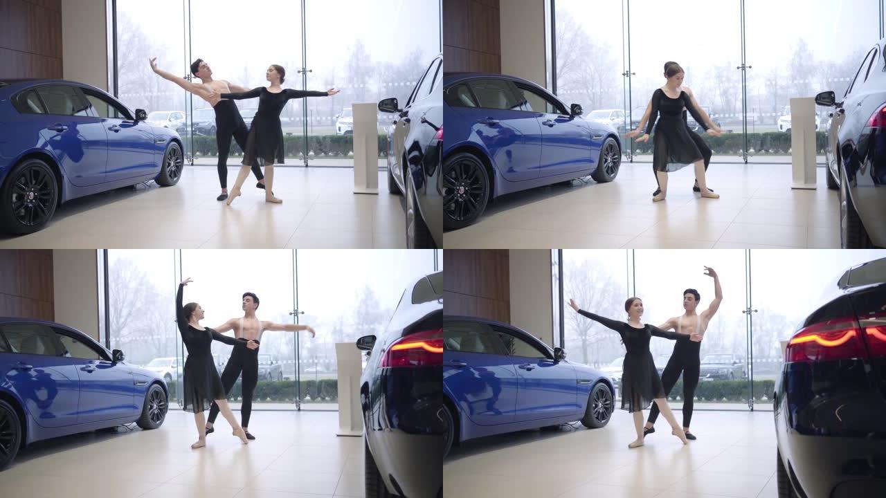 年轻的高加索芭蕾舞演员在汽车经销店跳舞的长镜头。男人和女人在汽车陈列室表演经典舞蹈。艺术，优雅，生活