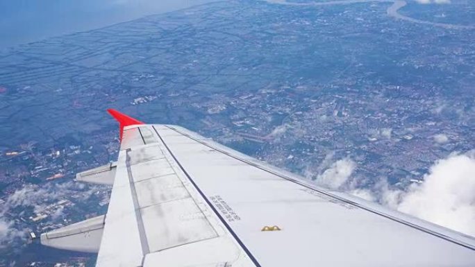 飞机在云层和城市上空飞行的4k镜头