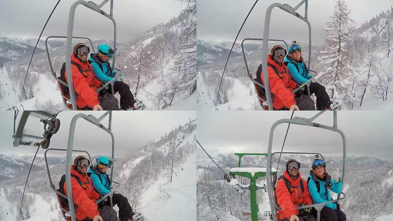 POV滑雪板夫妇骑着升降椅并制作视频