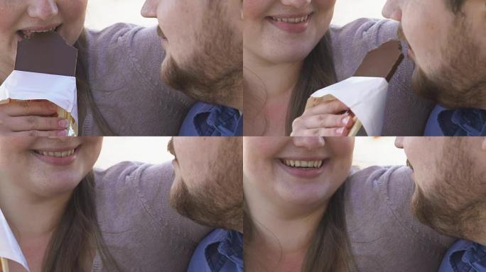 超重的女人咬巧克力，和她的胖男朋友分享，约会
