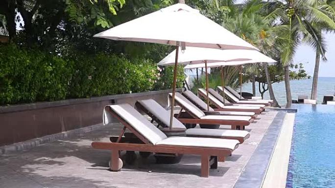 热带度假胜地游泳池附近的沙滩椅