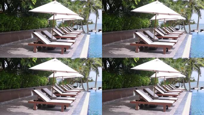 热带度假胜地游泳池附近的沙滩椅