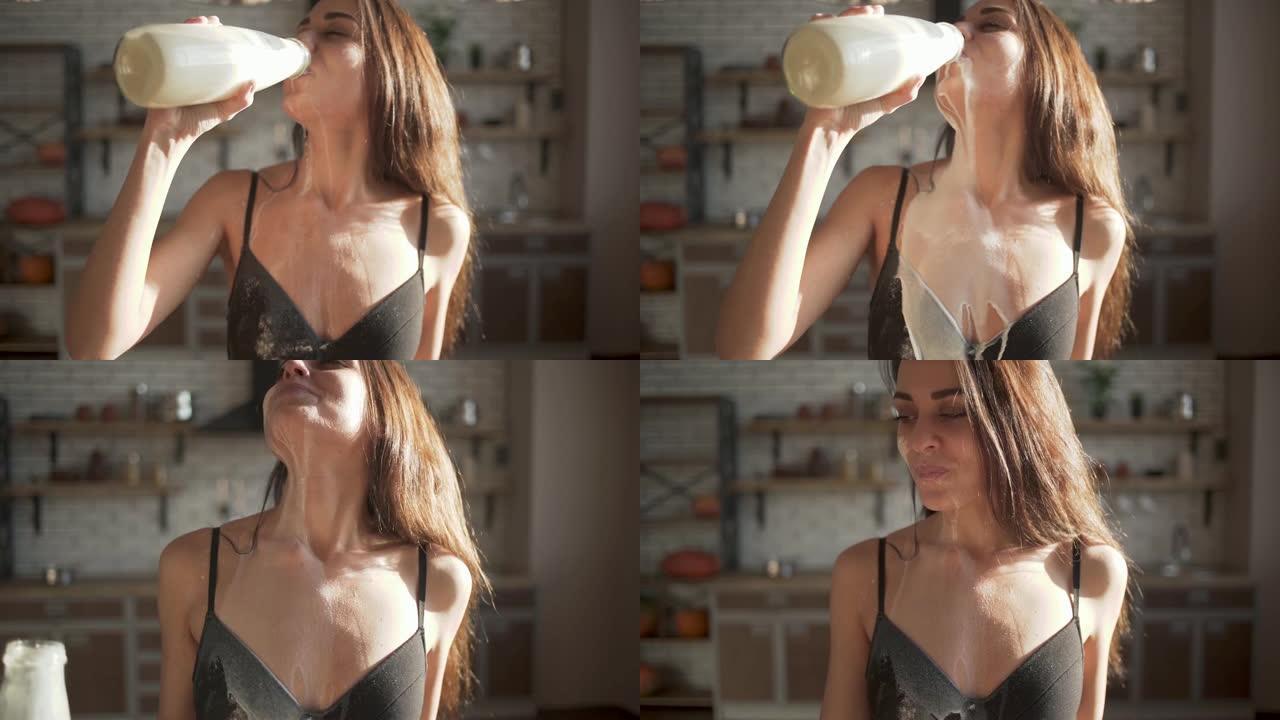 一个女人的肖像，完美的身体在内衣喝牛奶和洒一些。快乐的女孩在厨房喝酒。