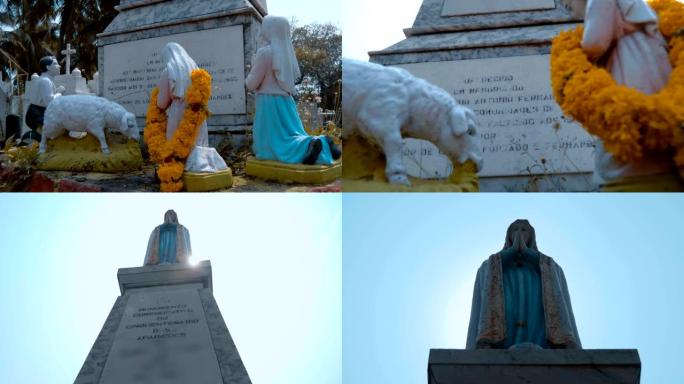 向印度果阿圣母玛利亚祈祷的女孩和男孩的白色雕像