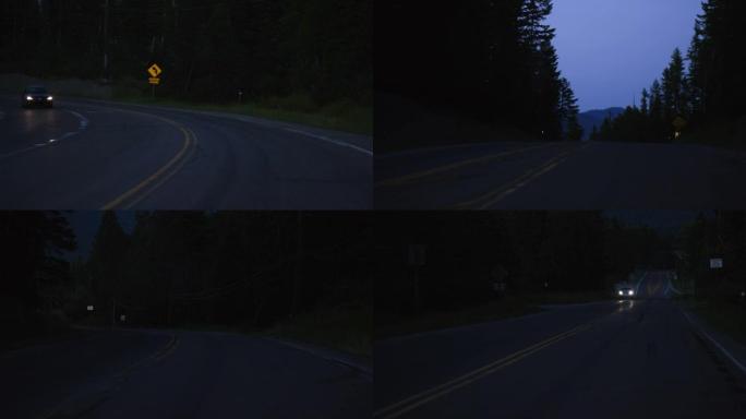 夜间在山中沿着树木环绕的道路行驶的车辆观点
