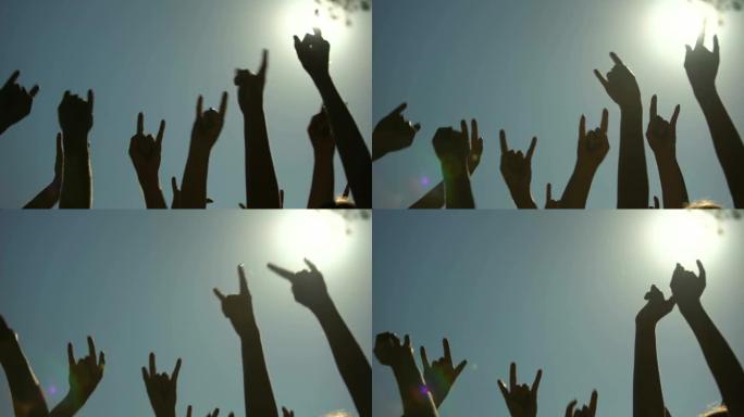 举起的手显示了号角手势的摇滚标志，摇滚音乐会，派对时间