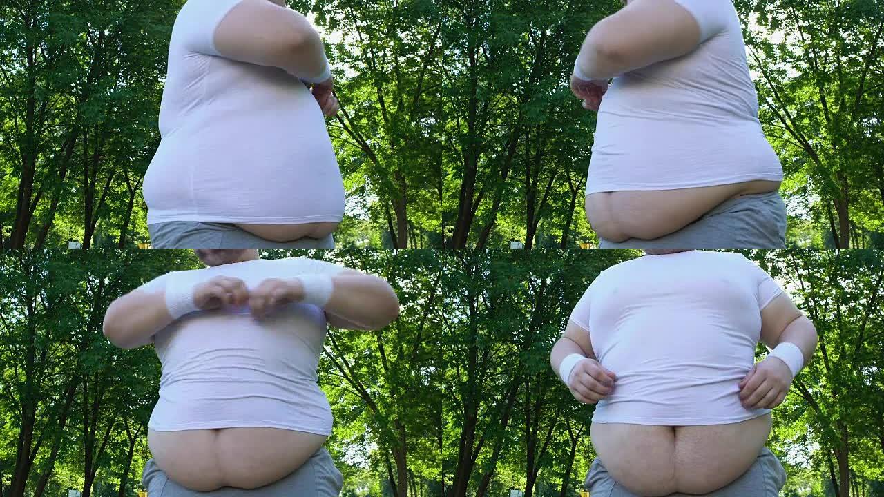 大肚子的胖乎乎的男人在城市公园做早操，每天锻炼