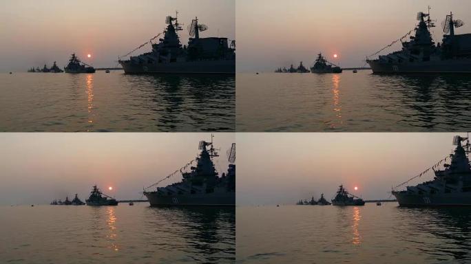 美丽的日落和停泊处的军舰剪影