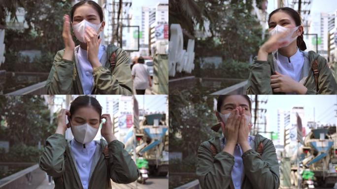 4k亚洲女性戴着鼻罩，防止空气中PM 2.5灰尘和Covid病毒。