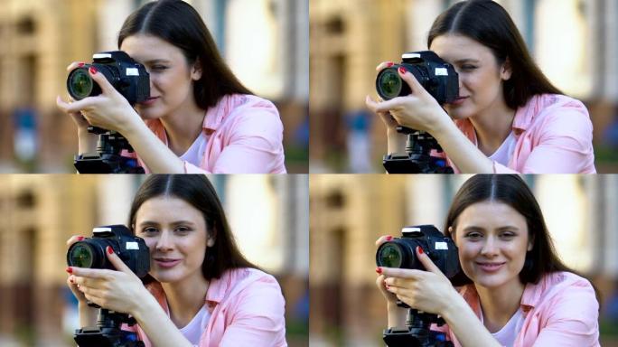 漂亮微笑的女摄影师校准相机镜头大众媒体职业
