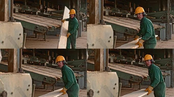 使用木材磨边机的男性锯木厂工人