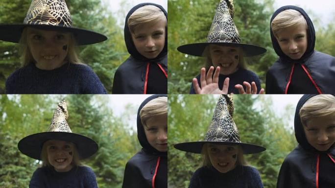 戴巫婆帽子的女孩和戴斗篷的男孩追逐相机，咆哮的幽灵，万圣节