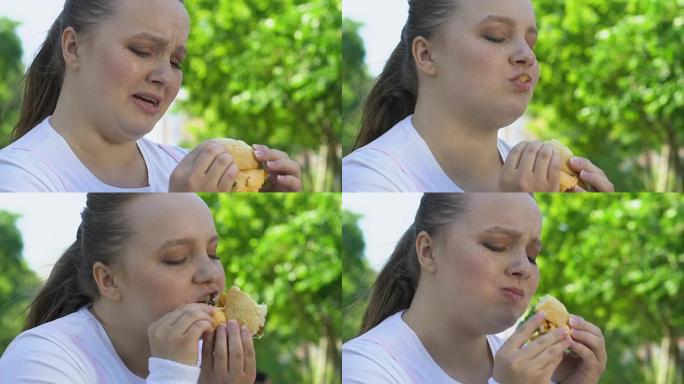 女孩吃高脂肪高热量汉堡快餐成瘾症意志力不足