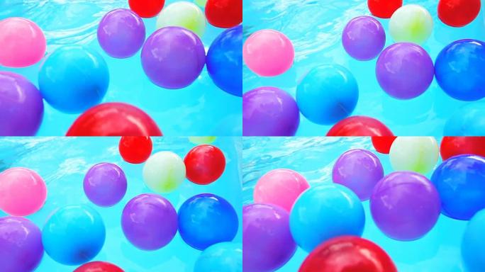 超级慢动作高清: 泳池里的彩球。
