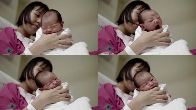 亚洲母亲在医院托儿所打婴儿