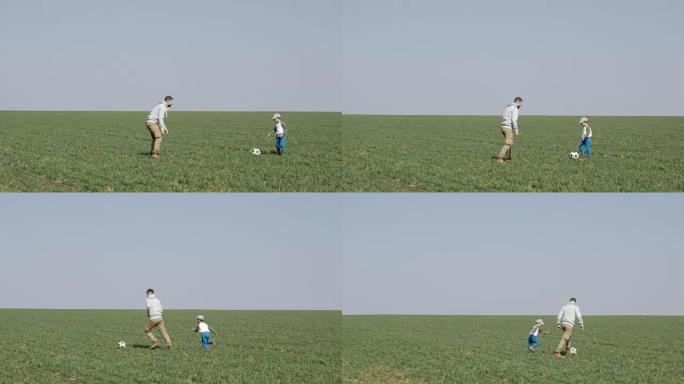 父亲和小儿子在户外踢足球