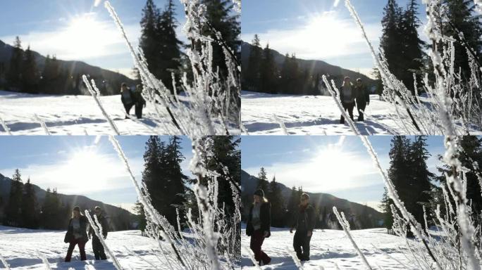 年轻男女沿着雪道散步