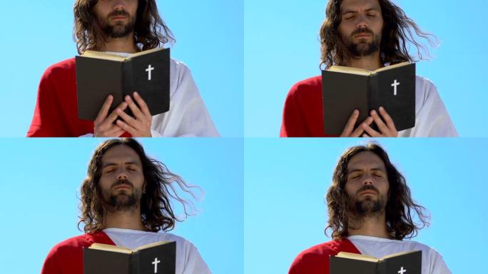 穿着长袍的耶稣读圣经，闭着眼睛祈祷上帝，宗教