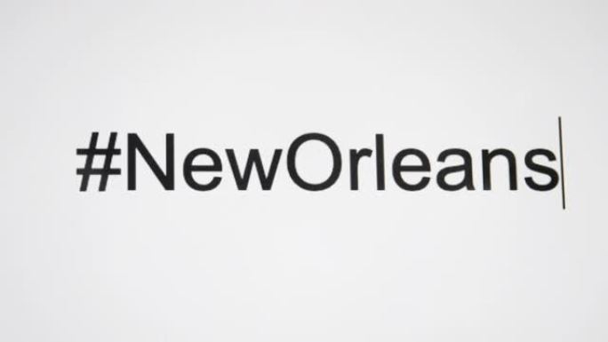 一个人在计算机屏幕上输入 “# NewOrleans”