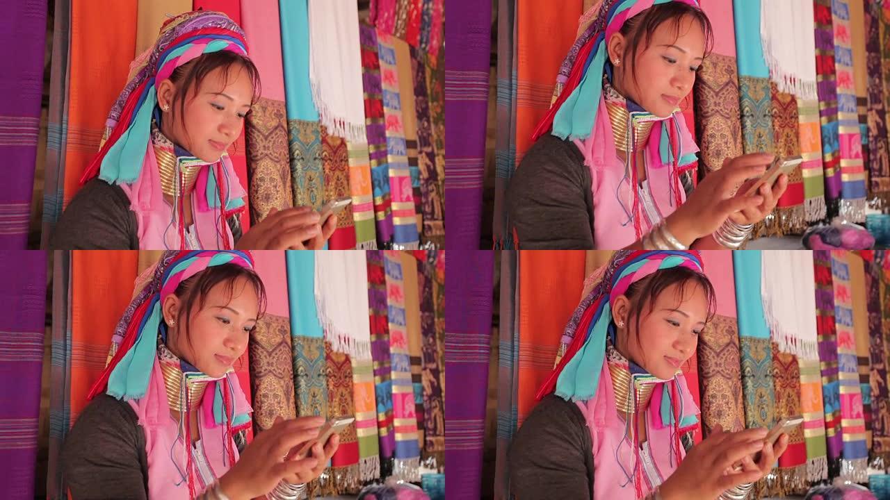 女人穿着传统的手机在村里编织