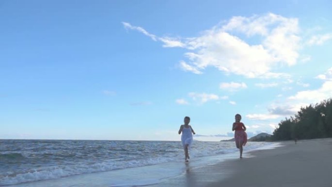 两个女孩在沙滩上玩耍和奔跑，慢动作