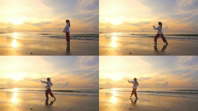 高清超慢动作: 日落时间在海滩上户外练习武术的年轻女性