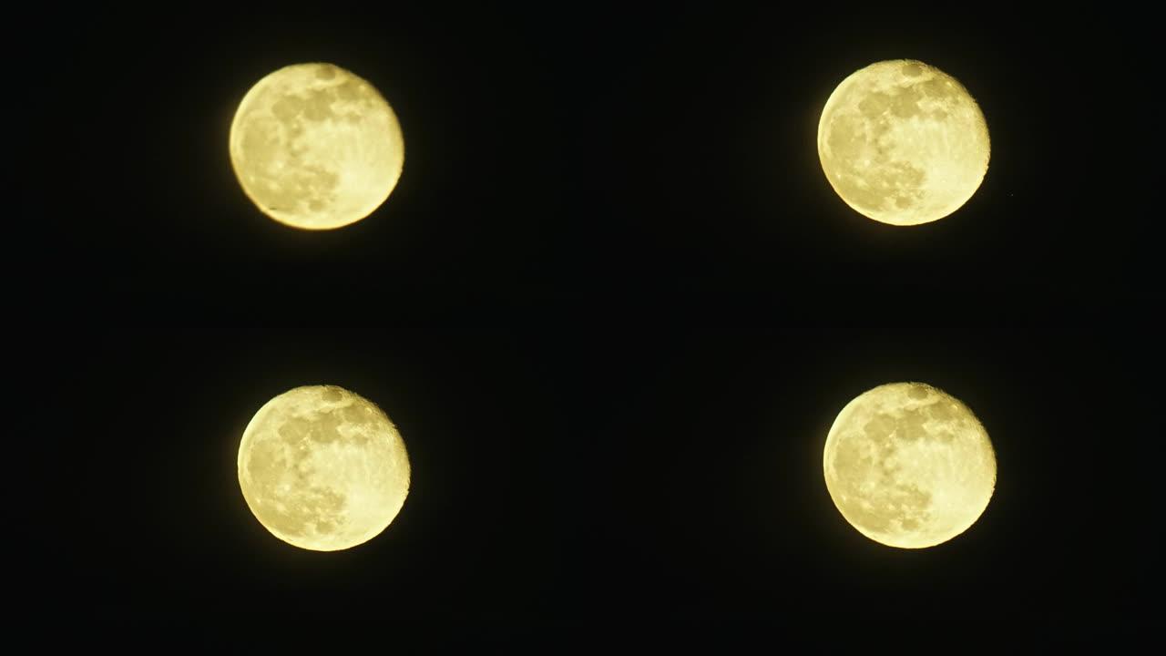 当喷气式飞机在月亮和相机之间飞行时，一个几乎满月的大月 (变圆的凸块) 发出黄色的光芒